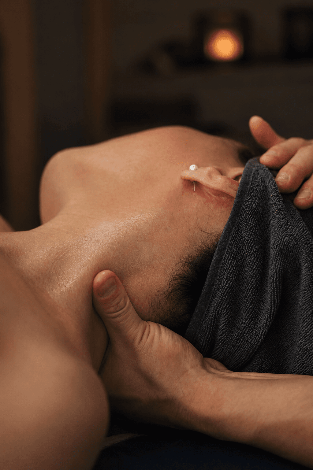 Focused neck and shoulder massage work in a calm treatment room at Muscle Movement and Improvement