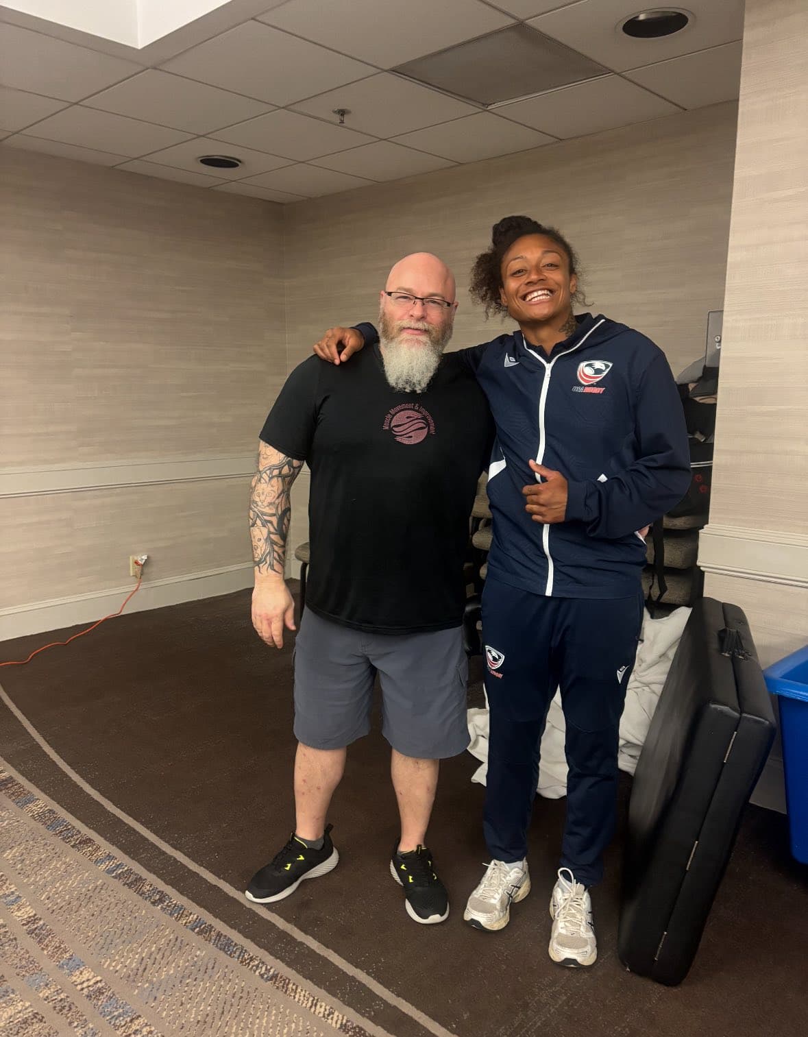 Chris Cox with an athlete after providing sports massage support
