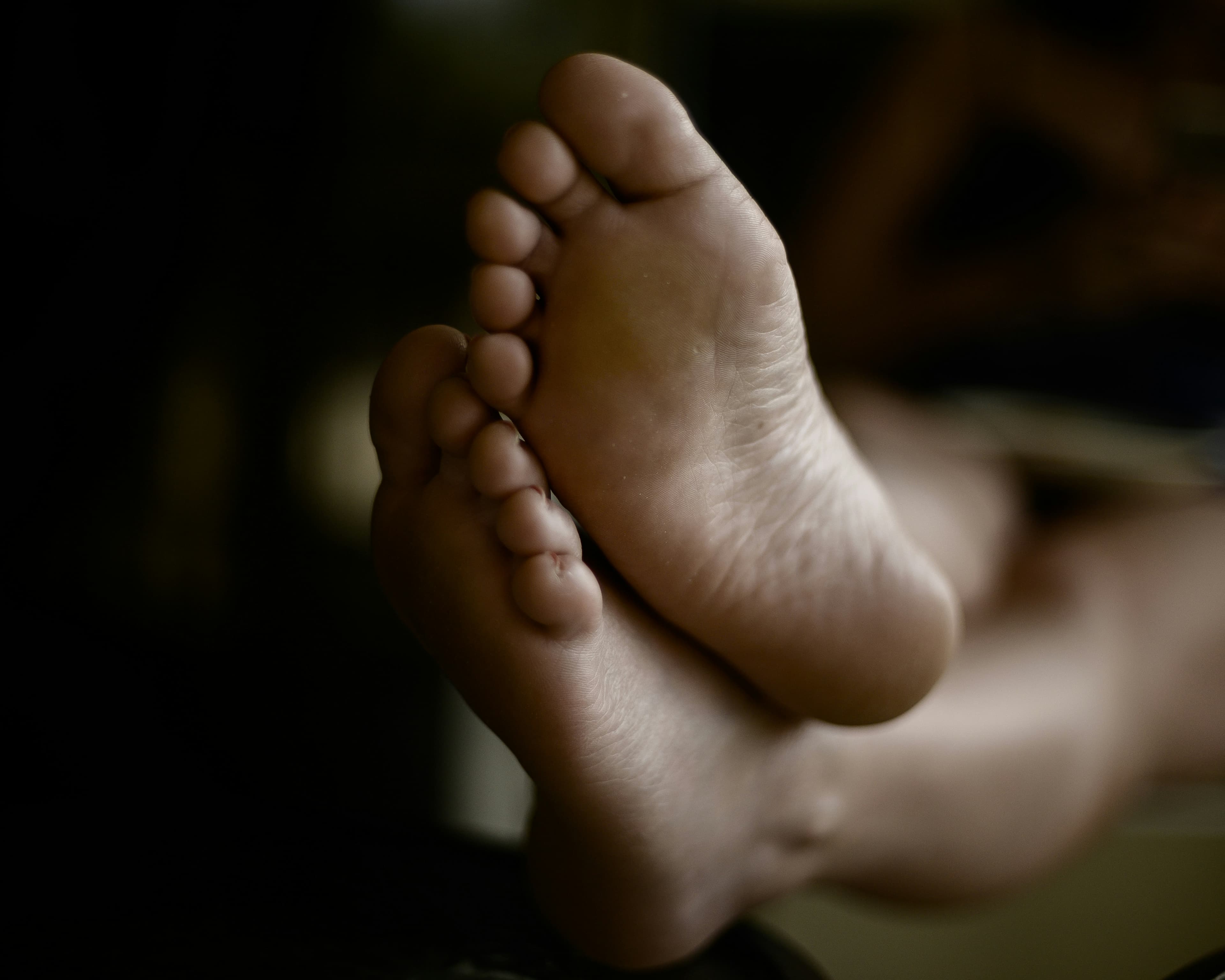 Close-up of relaxed feet before a reflexology-focused massage session