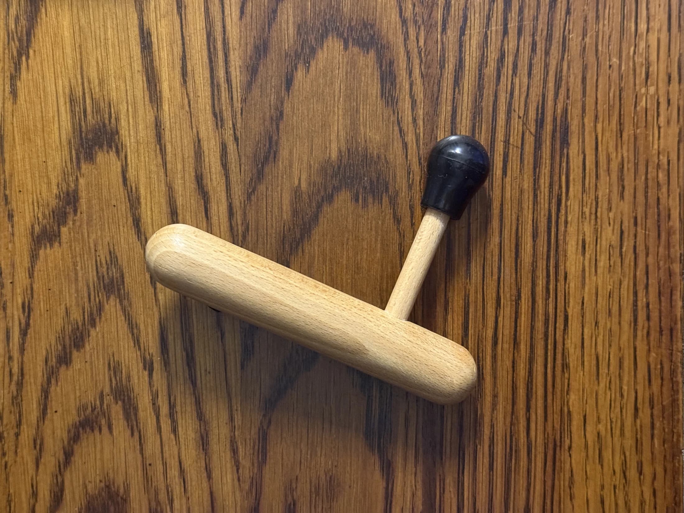 Two wooden pressure tools used for focused bodywork